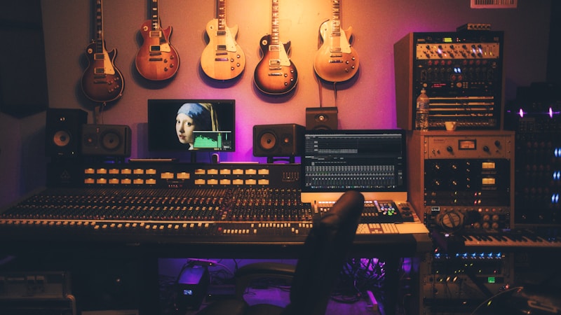 Production crew collaborating at a live venue with laptops and instruments
